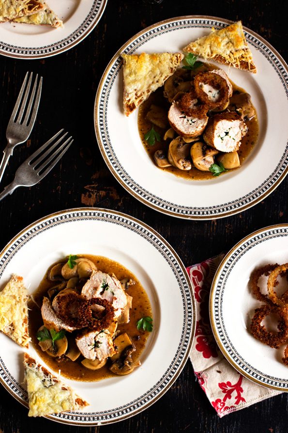 Parsley Butter Chicken Roulade with Spicy Mushrooms, Crispy Onion Rings and Parmesan Toasts