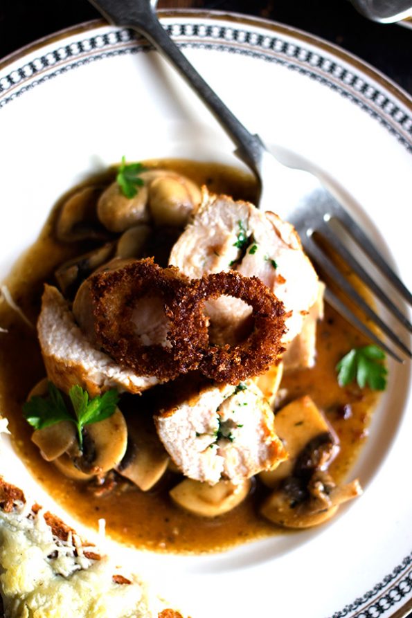 Parsley Butter Chicken Roulade with Spicy Mushrooms, Crispy Onion Rings and Parmesan Toasts