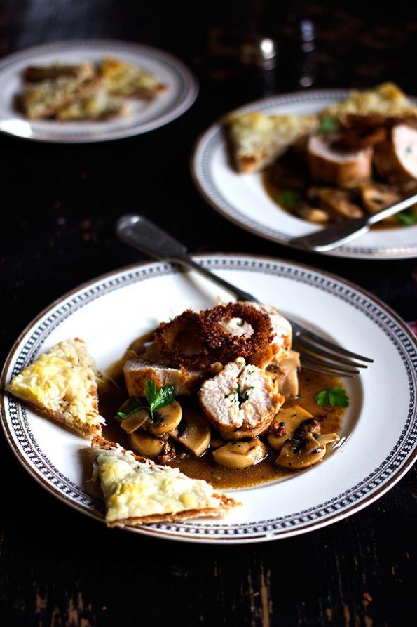 Parsley Butter Chicken Roulade with Spicy Mushrooms, Crispy Onion Rings and Parmesan Toasts