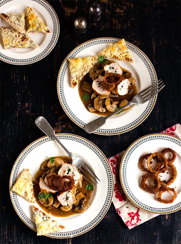 Parsley Butter Chicken Roulade with Spicy Mushrooms, Crispy Onion Rings and Parmesan Toasts